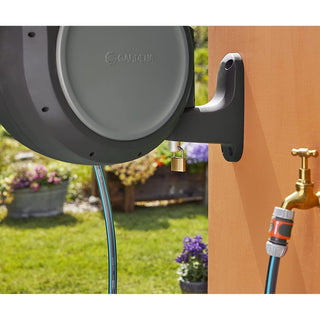 Gardena RollUp reel on its bracket beside an outdoor faucet