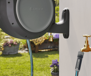 Gardena RollUp reel on its wall bracket beside a faucet