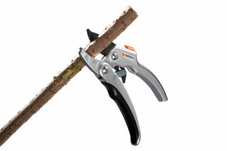 Gardena ratchet pruners closing on a dry wooden stick