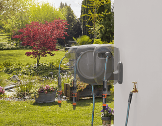 Gardena RollUp reel swung out on its wall bracket