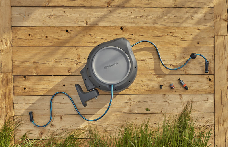 Gardena RollUp reel and its parts laid out on a wooden deck