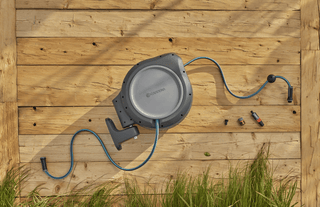 Gardena RollUp reel and its parts laid out on a wooden deck